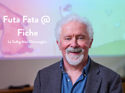 Tadhg Mac Dhonnagáin against pink and green backdrop