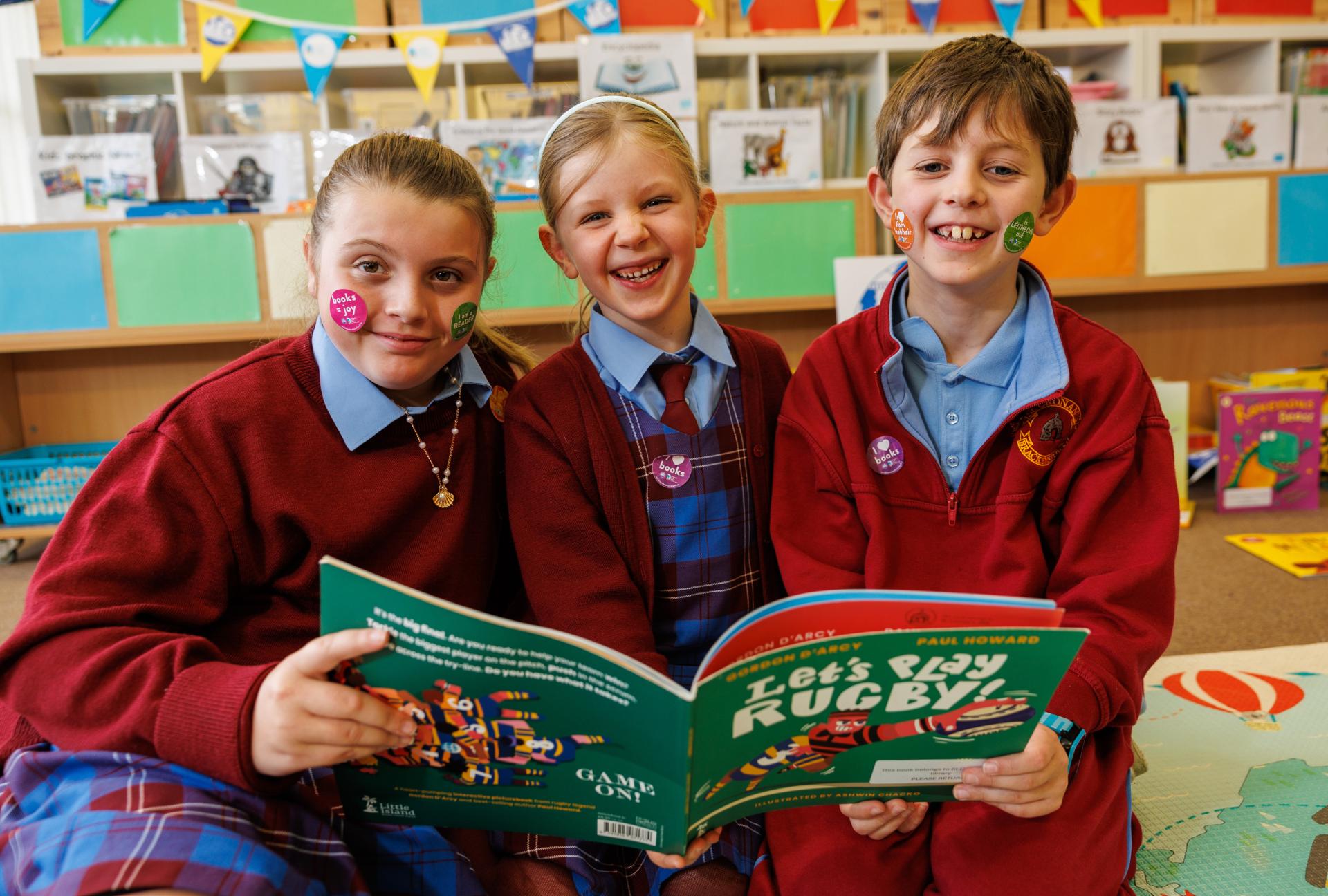 St Cronan's Senior NS students with a book