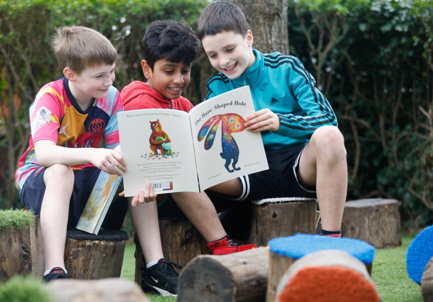 boys reading in garden
